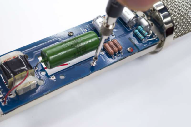 D-12 PCB secured into the body with screws: two at the top, and short/long screws at the bottom.
